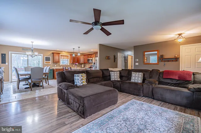 a dining table with chairs and kitchen view