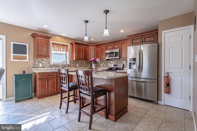 a kitchen with stainless steel appliances granite countertop a sink stove and microwave