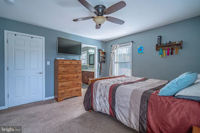 a bedroom with a bed and dresser