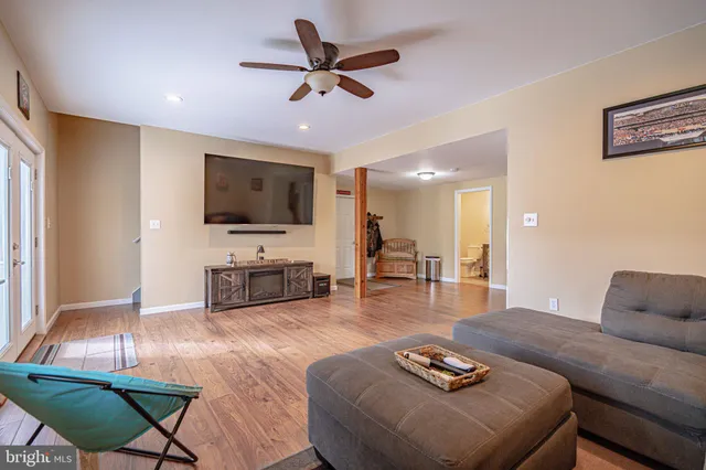a view of a workspace with furniture and wooden floor