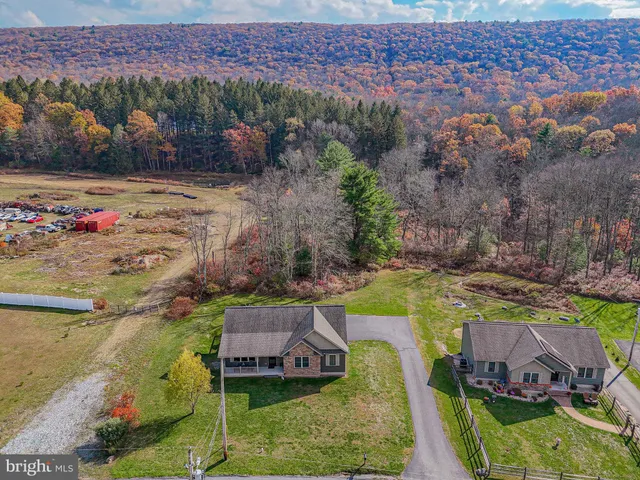 an aerial view of a house with a yard basket ball court