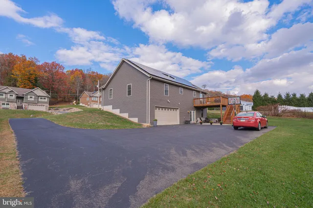 a view of a house with backyard and porch