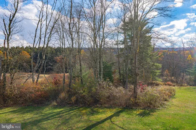 an aerial view of a house with a yard basket ball court