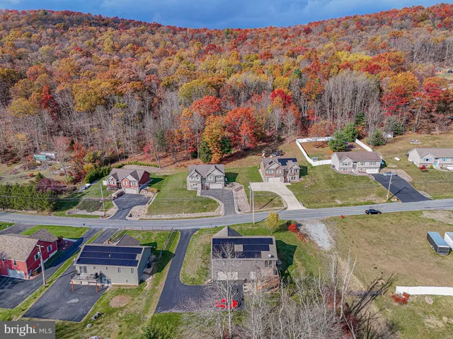 an aerial view of residential houses with outdoor space