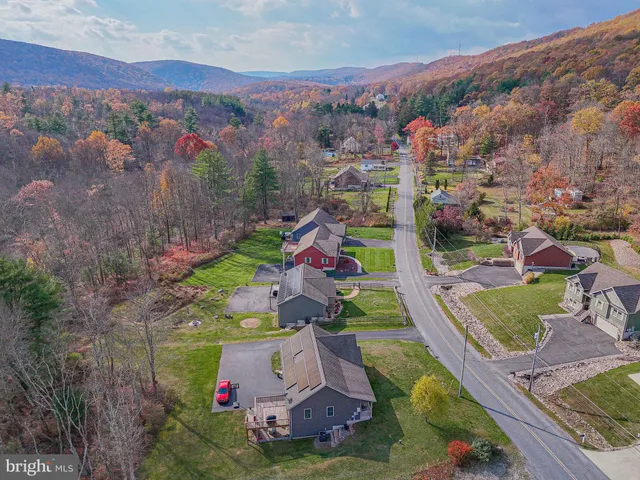 an aerial view of residential houses with outdoor space