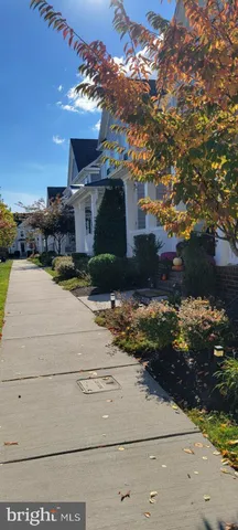 a kitchen with granite countertop a refrigerator and a stove top oven