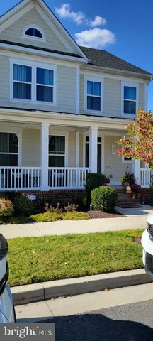 a large white kitchen with sink and a refrigerator
