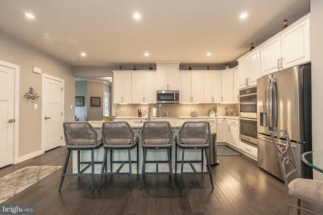 a living room with lots of furniture and kitchen view