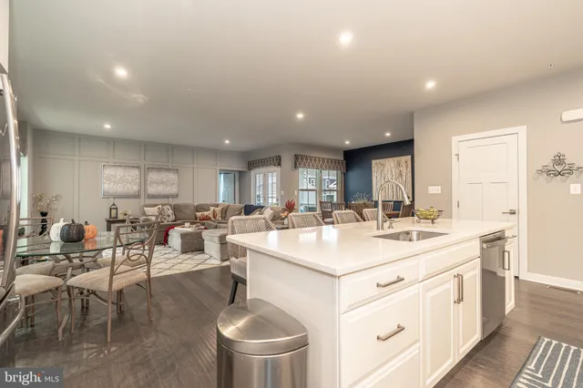 a living room with furniture flat screen tv and wooden floor