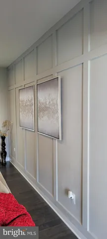 a living room with furniture and a dining table with wooden floor