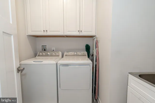 a bedroom with a bed and a lamp on dresser