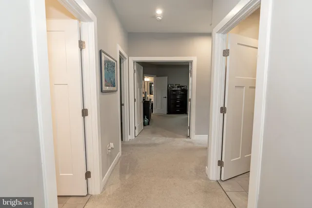 a spacious bathroom with a shower a sink and a mirror