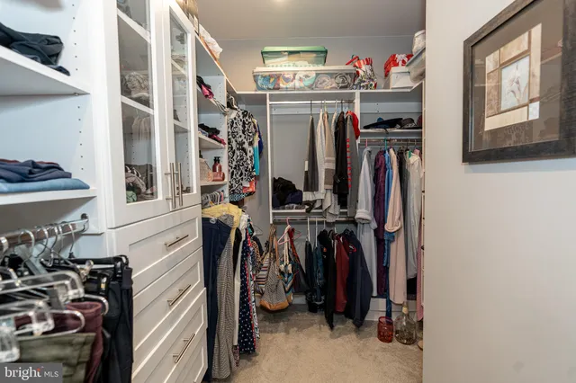 a living room with furniture and view of kitchen