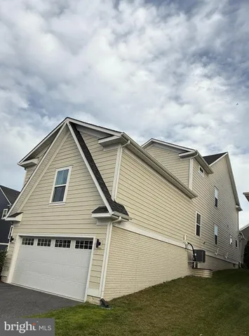 a view of house with backyard