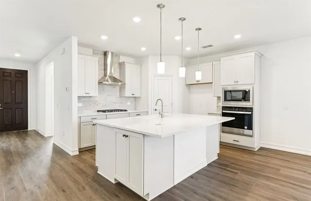 a kitchen with a sink stainless steel appliances and cabinets