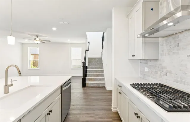 a kitchen with a stove a sink and a refrigerator