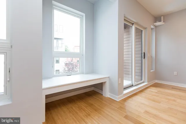 a view of room with window and hardwood floor