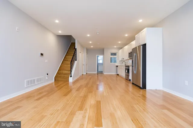 a view of empty room with wooden floor