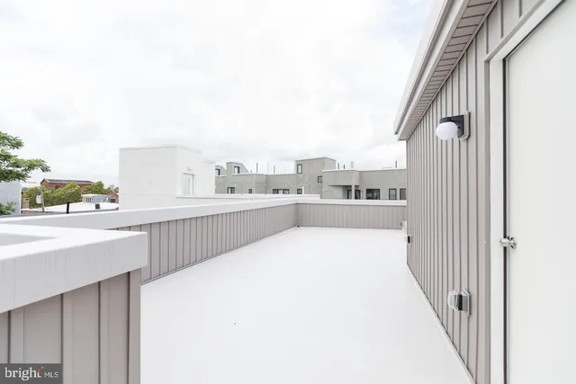 a view of a kitchen with kitchen island and a sink