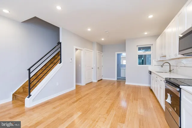 a view of a kitchen with a sink and cabinets