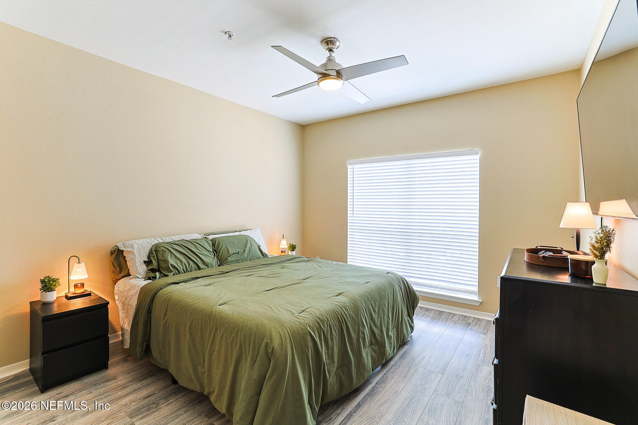 10961 Burnt Mill Road, Unit 426 Jacksonville, FL 32256 - Photo 13 of 24 a bedroom with a bed and a chandelier
