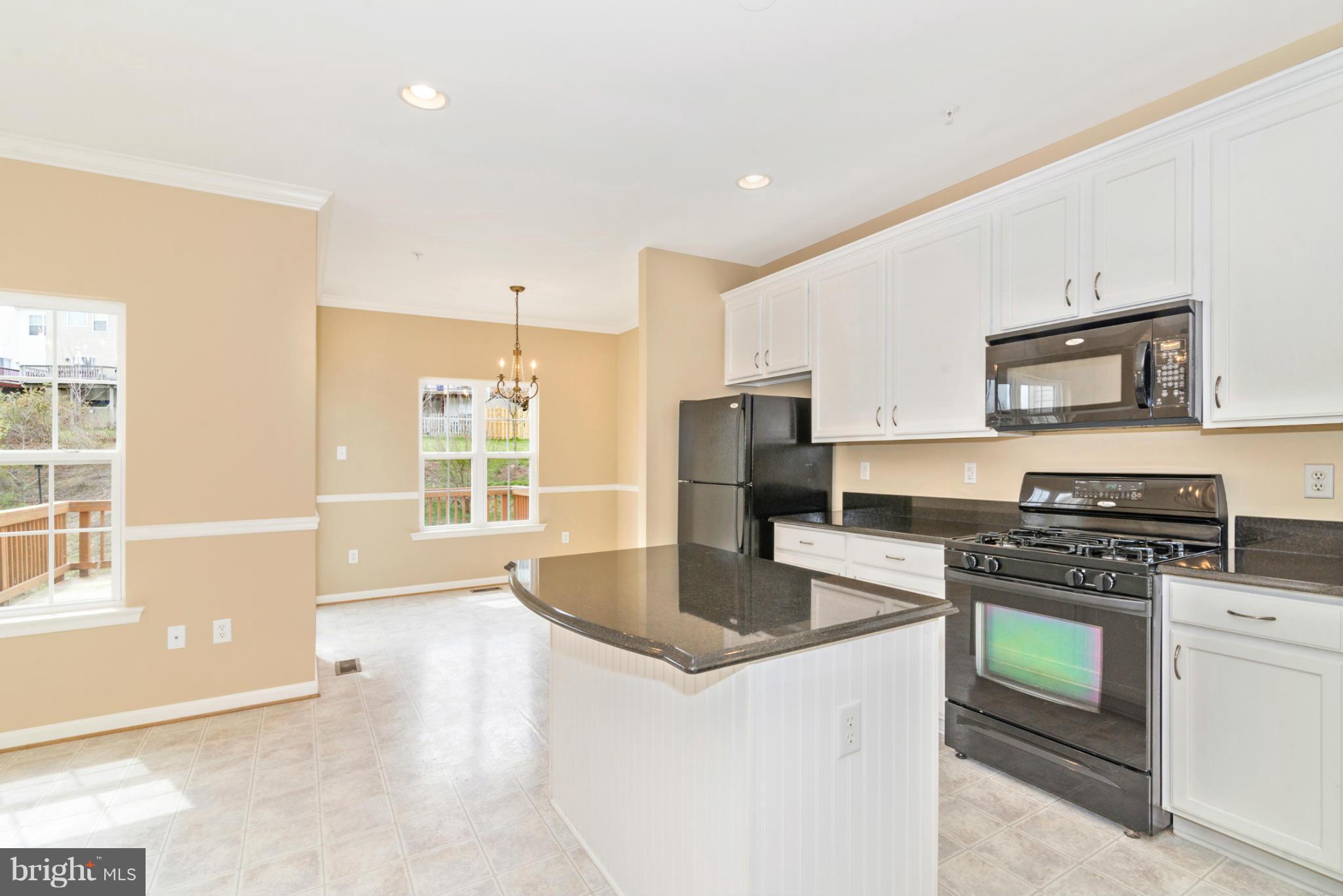 1608 Trestle Street Mount Airy, MD 21771 - Photo 13 of 24 a kitchen with stainless steel appliances granite countertop a sink stove and refrigerator