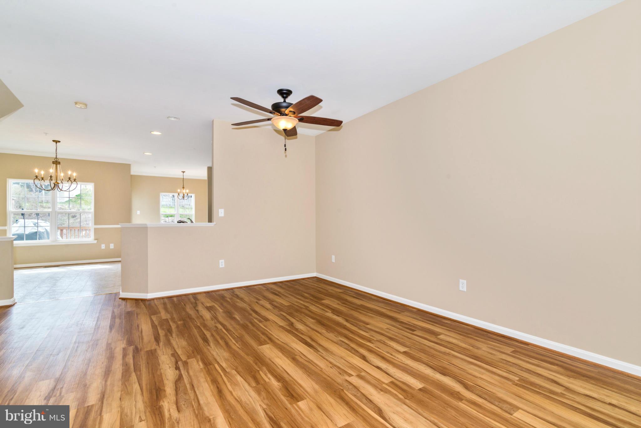 1608 Trestle Street Mount Airy, MD 21771 - Photo 8 of 24 a view of a room with wooden floor and a ceiling fan