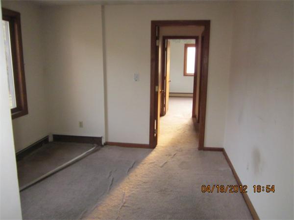 160 Ayer Road, Unit A Shirley, MA 01464 - Photo 3 of 7 a view of a hallway with wooden floor and a bathroom