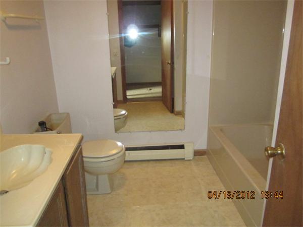 160 Ayer Road, Unit A Shirley, MA 01464 - Photo 5 of 7 a bathroom with a sink a toilet and shower