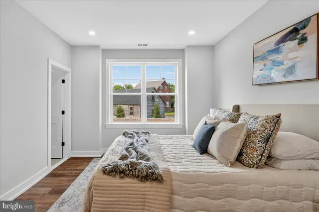 a room with a bed and glass window