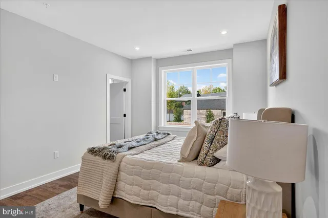 a bedroom with a bed and a painting on the wall