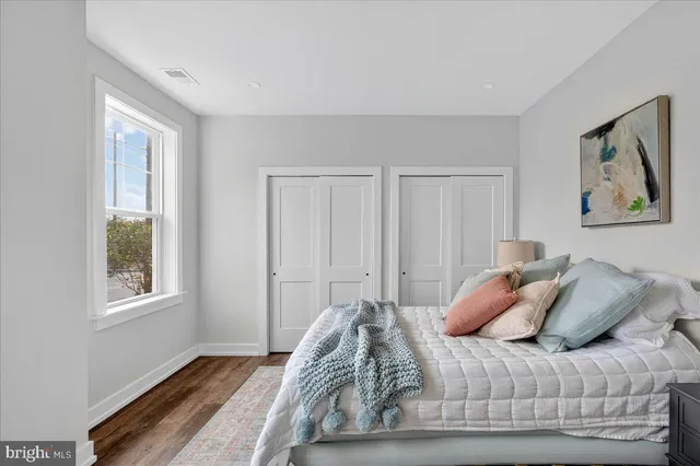 a bedroom with bed and a window