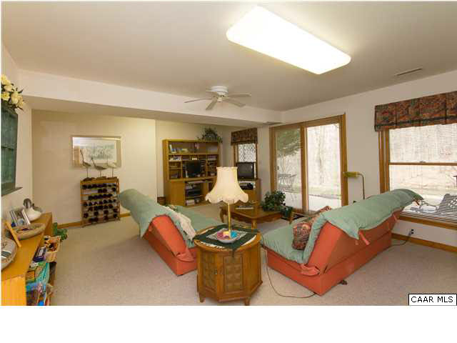 1011 Broken Island Road Palmyra, VA 22963 - Photo 26 of 38 Family Room with Walk-out to Aggregate Patio Overlooking Lake