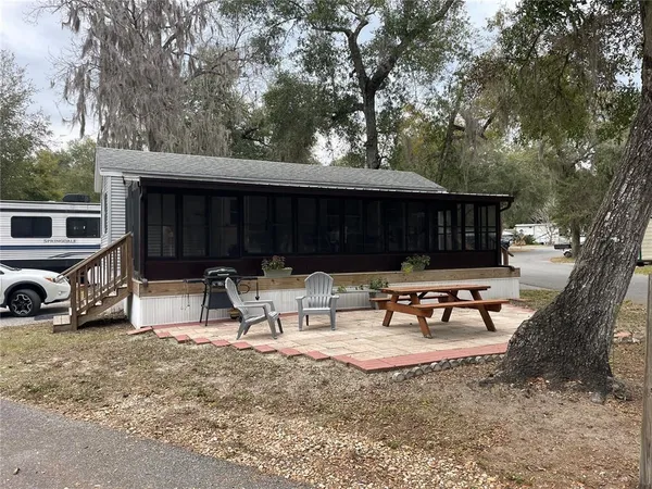 a view of a backyard with a sitting area