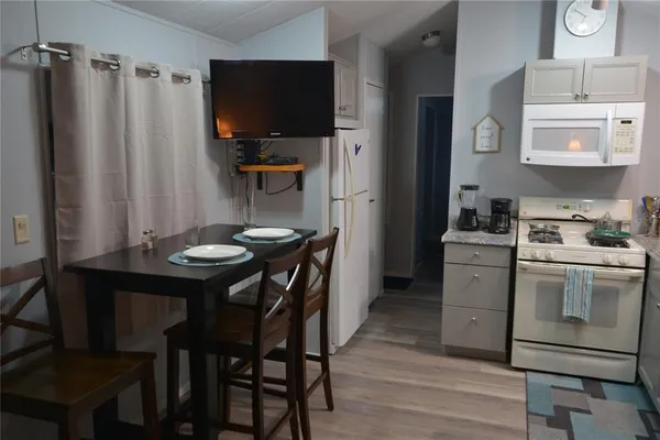 a kitchen with a table and chairs in it