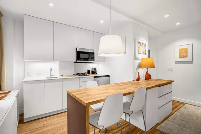 a view of a dining room with furniture and a window