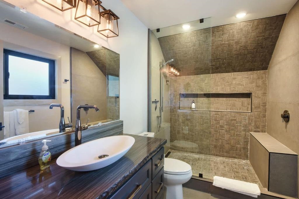 1163 Statford Way Tahoe Vista, CA 96148 - Photo 15 of 22 a bathroom with a sink a toilet a mirror and shower