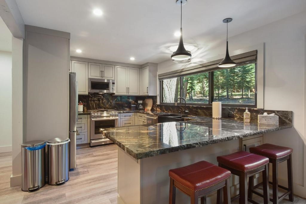1163 Statford Way Tahoe Vista, CA 96148 - Photo 5 of 22 a kitchen with stainless steel appliances granite countertop a stove a sink and a microwave