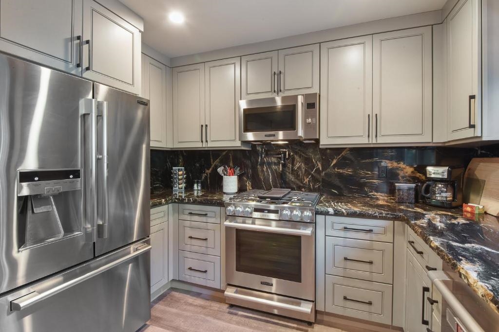 1163 Statford Way Tahoe Vista, CA 96148 - Photo 7 of 22 a kitchen with stainless steel appliances granite countertop a stove a refrigerator and a microwave