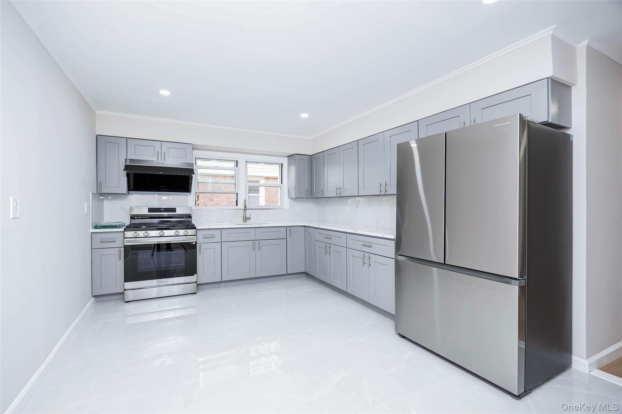 157-19 16th Road Queens, NY 11357 - Photo 12 of 33 a kitchen with stainless steel appliances a refrigerator and a stove top oven
