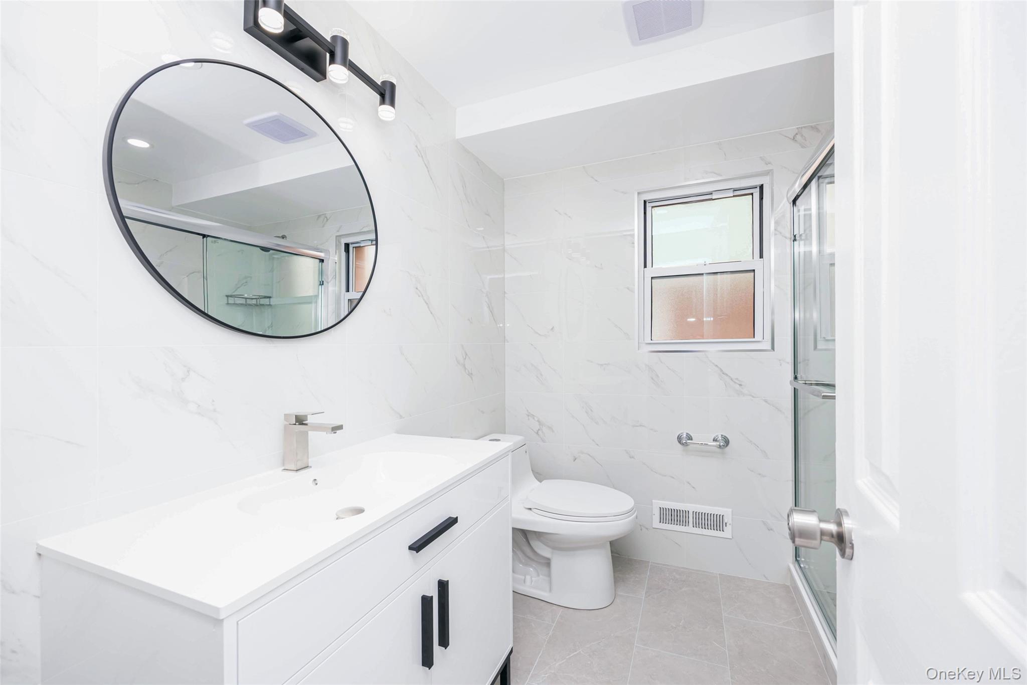 157-19 16th Road Queens, NY 11357 - Photo 13 of 33 a bathroom with a sink and a mirror