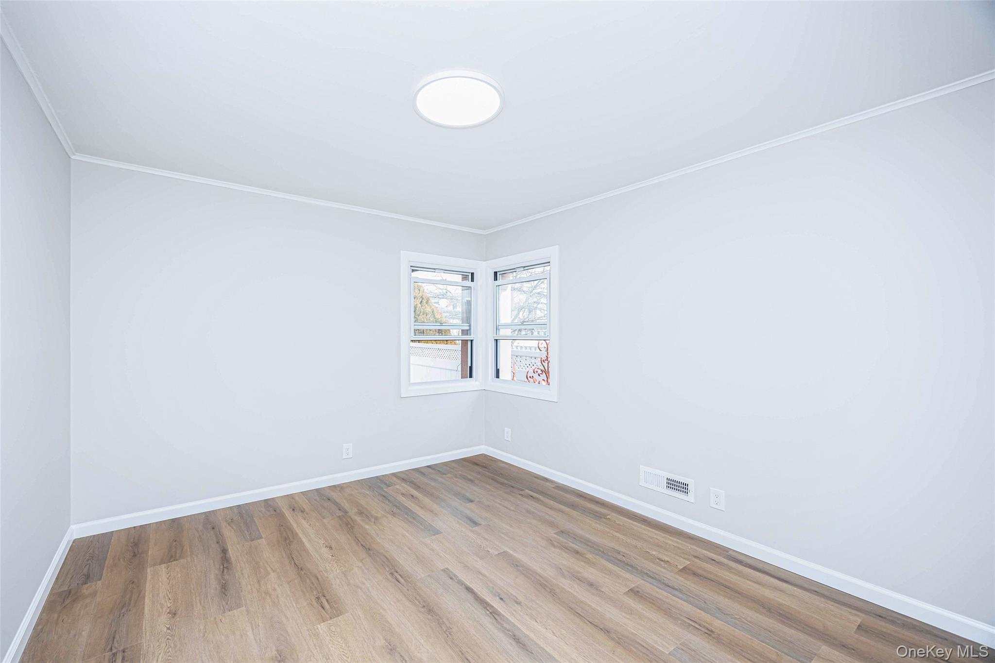 157-19 16th Road Queens, NY 11357 - Photo 17 of 33 an empty room with a window