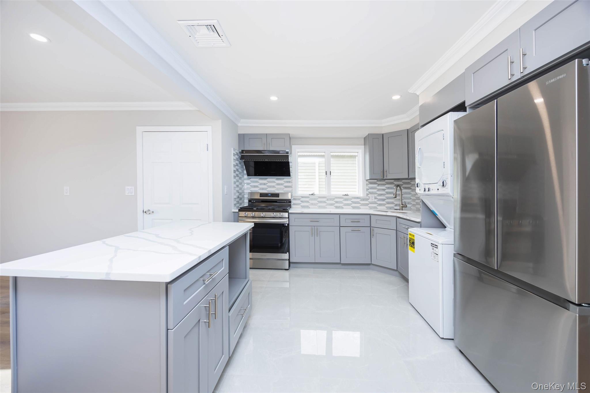 157-19 16th Road Queens, NY 11357 - Photo 25 of 33 a kitchen with a refrigerator a sink and a stove