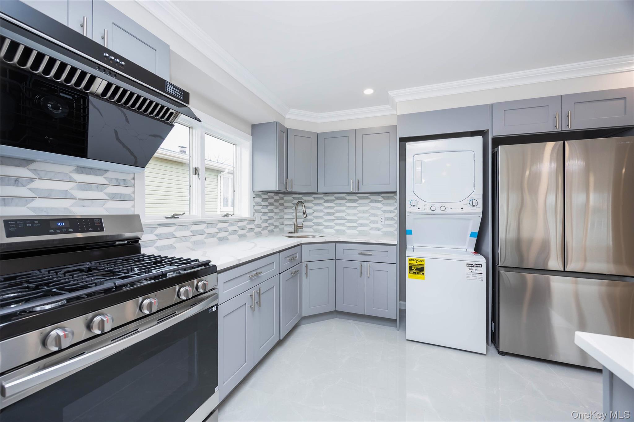 157-19 16th Road Queens, NY 11357 - Photo 26 of 33 a kitchen with stainless steel appliances granite countertop a sink and a refrigerator
