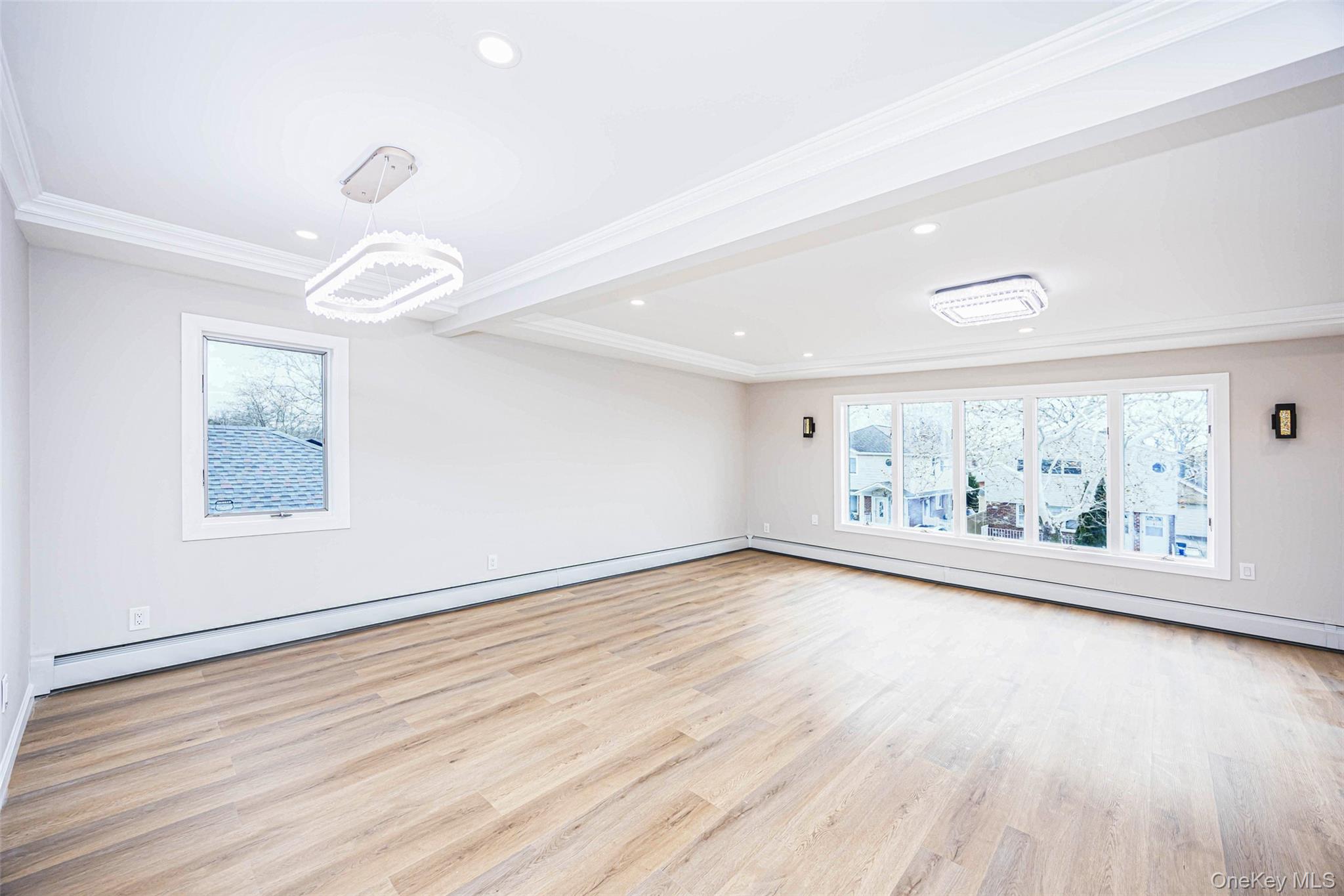 157-19 16th Road Queens, NY 11357 - Photo 27 of 33 an empty room with wooden floor fan and windows