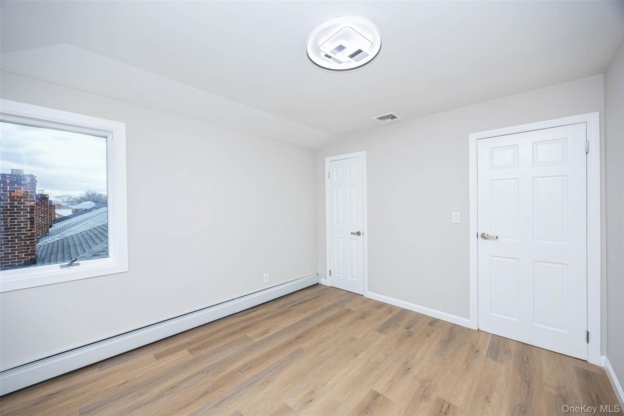 157-19 16th Road Queens, NY 11357 - Photo 29 of 33 a view of a room with wooden floor and window