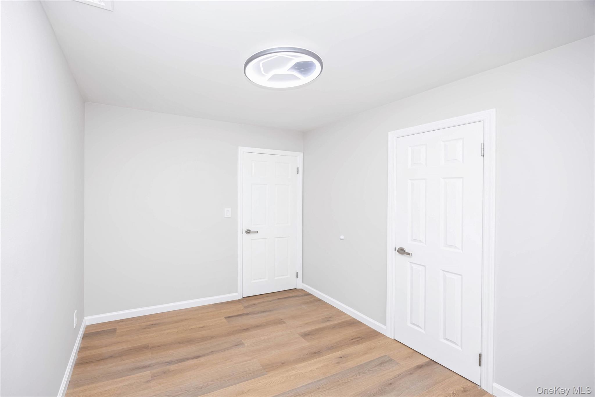 157-19 16th Road Queens, NY 11357 - Photo 30 of 33 a view of a livingroom with wooden floor and a ceiling fan
