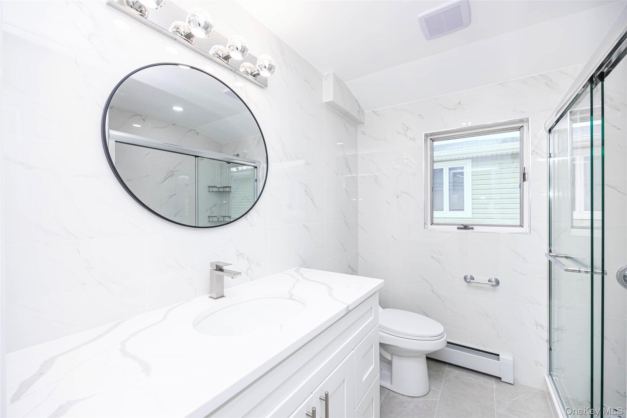 157-19 16th Road Queens, NY 11357 - Photo 31 of 33 a bathroom with a sink a mirror and a toilet