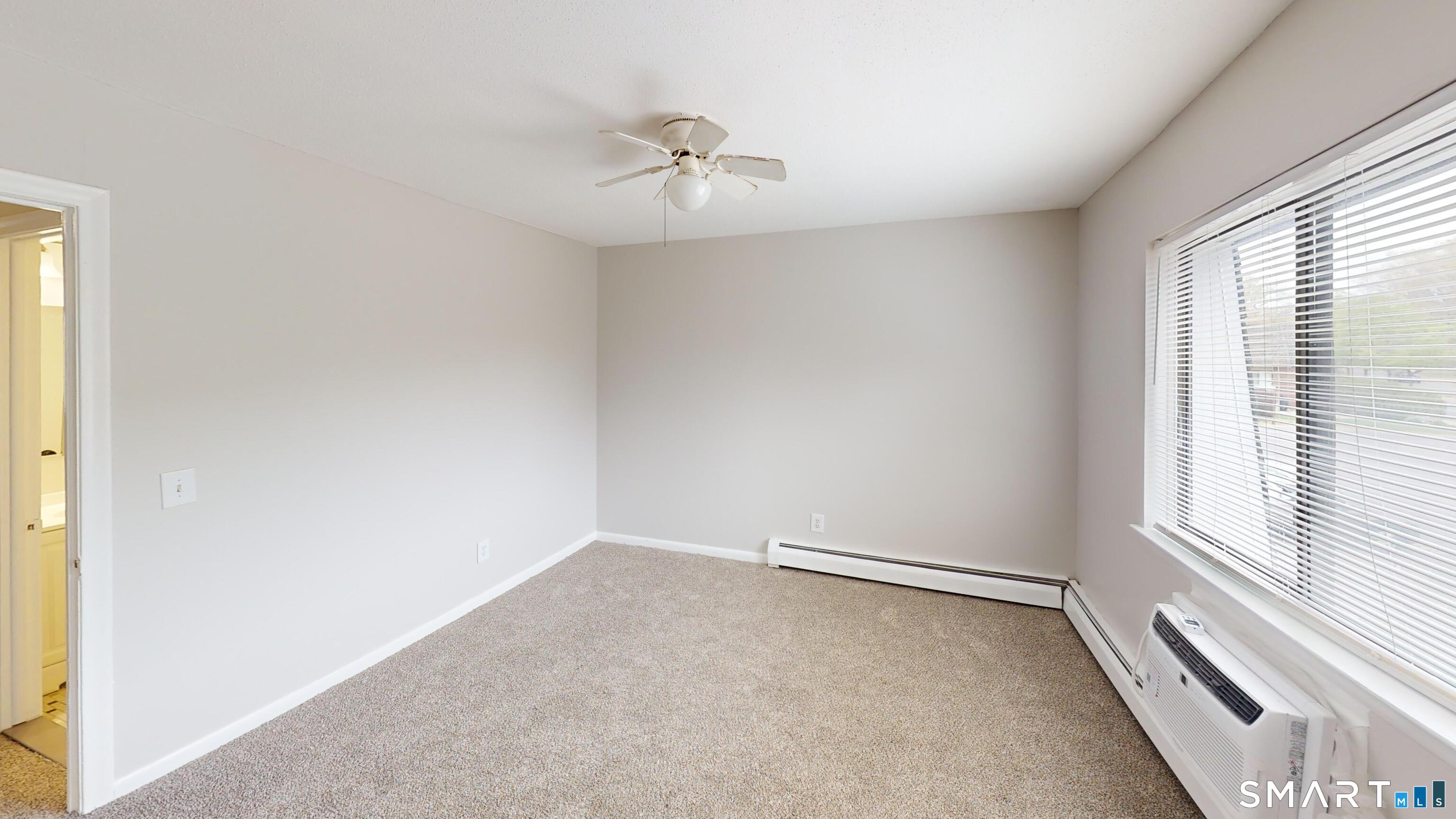 158 High Path Road, Unit 158 Windsor, CT 06095 - Photo 10 of 20 an empty room with a window and a fan