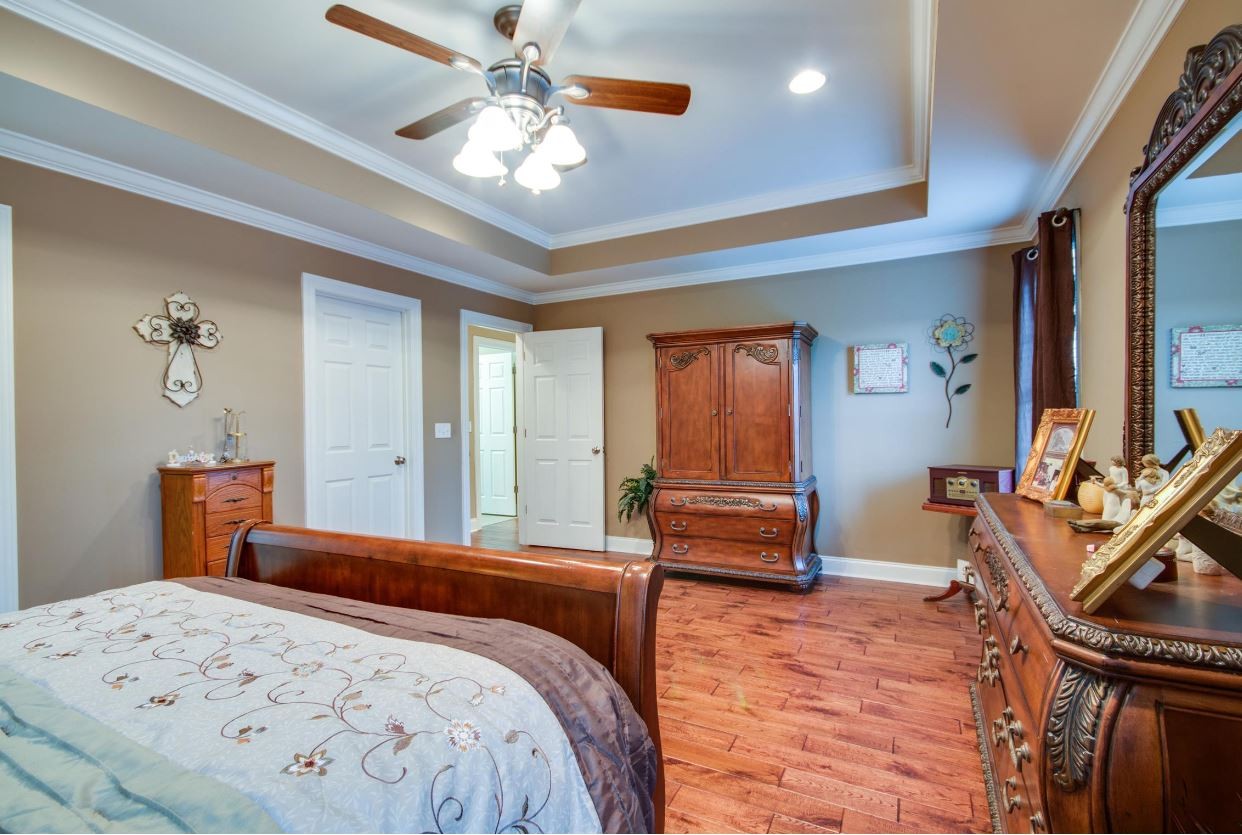 92 Freeman Court Winchester, TN 37398 - Photo 14 of 19 a bedroom with a bed and a chandelier